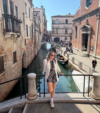 Cheryl on a bridge over a quiet Venetian canal
