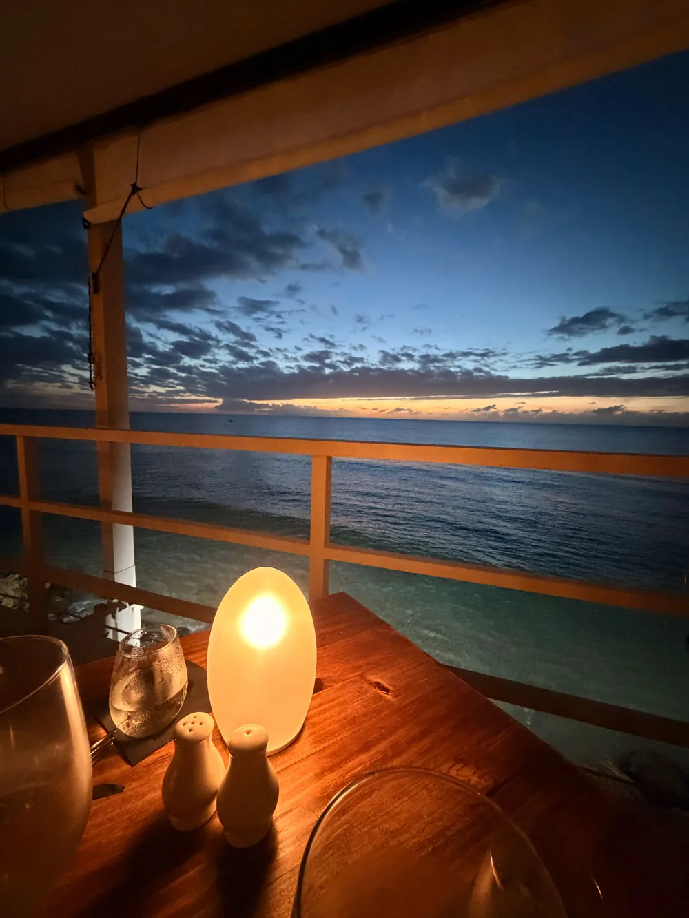 A candlelit table looking out to a Caribbean sunset