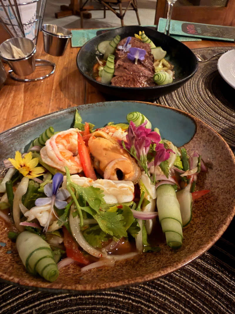 Breakfast spread at Celeste Hotel Koh Samui featuring fresh fruit, pastries and Thai dishes