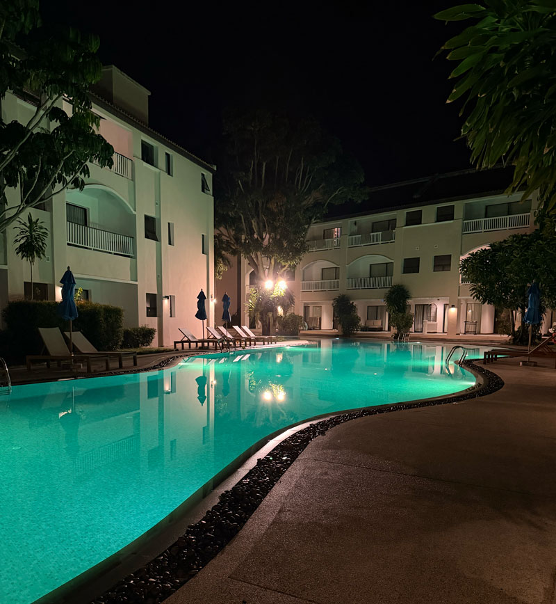 Celeste Hotel swimming pool at night, illuminated and overlooking the sea in Koh Samui, Thailand