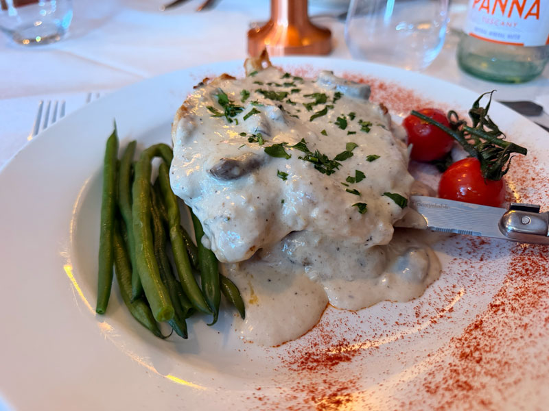 Chicken supreme with creamy mushroom sauce, green beans and cherry tomatoes at Amici Ristorante, Ashford