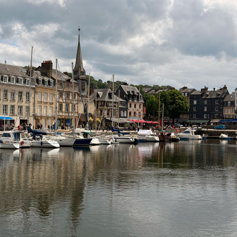 Boats moored along the old harbour at Honfleur