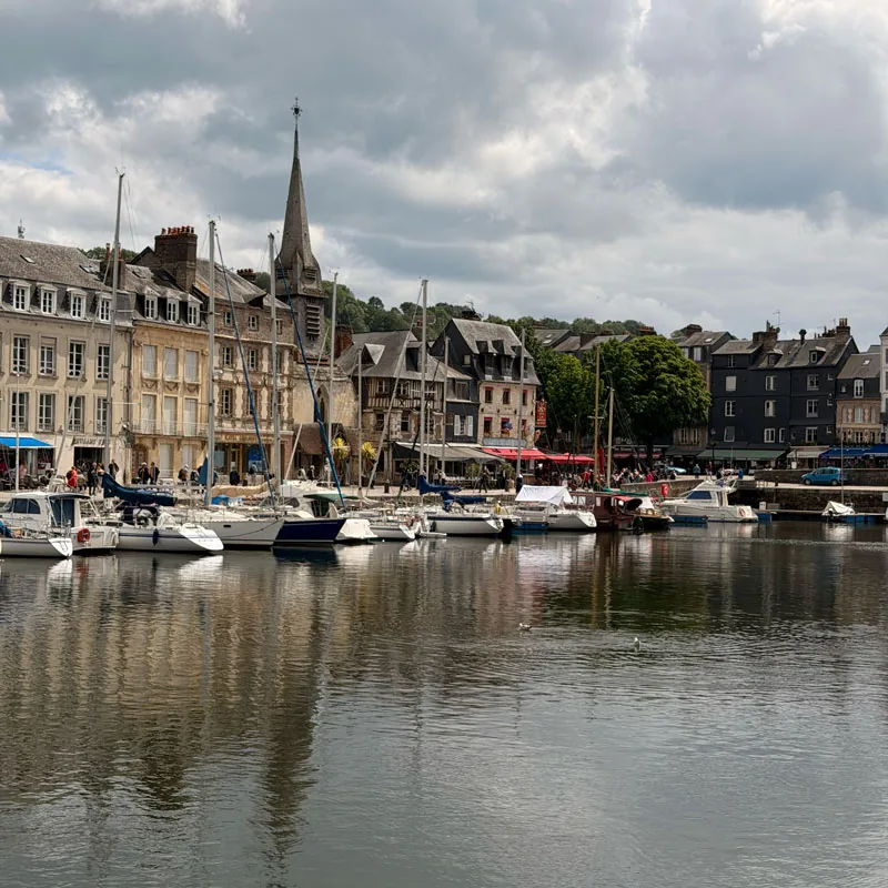 Boats moored along the old harbour at Honfleur