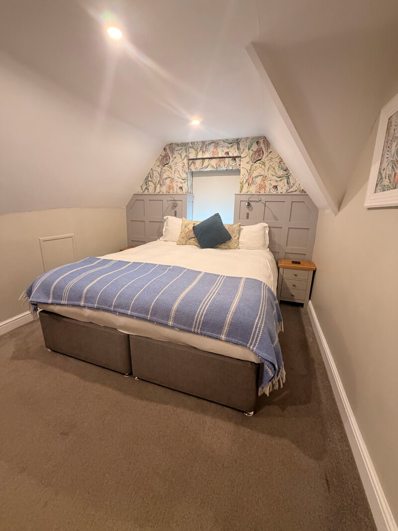 Cosy bedroom at the Old New Inn Bourton-on-the-Water with large comfortable bed and Cotswolds decor