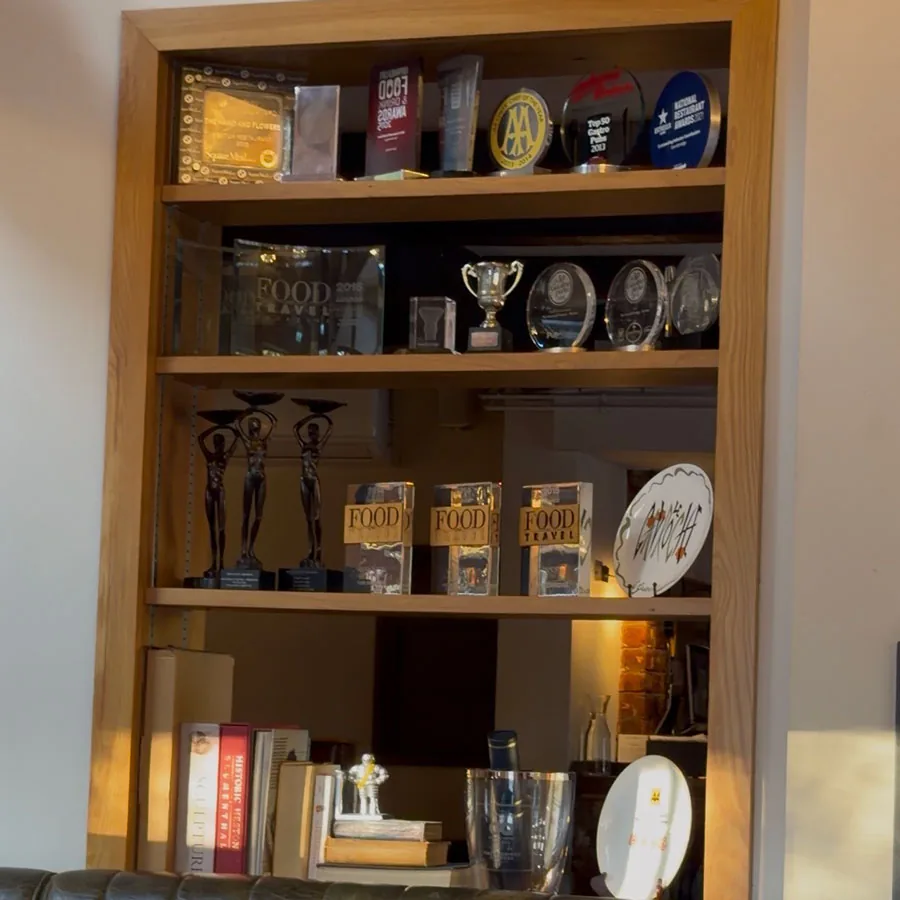 Tom Kerridge's awards and accolades displayed on a shelf at The Hand and Flowers, Marlow