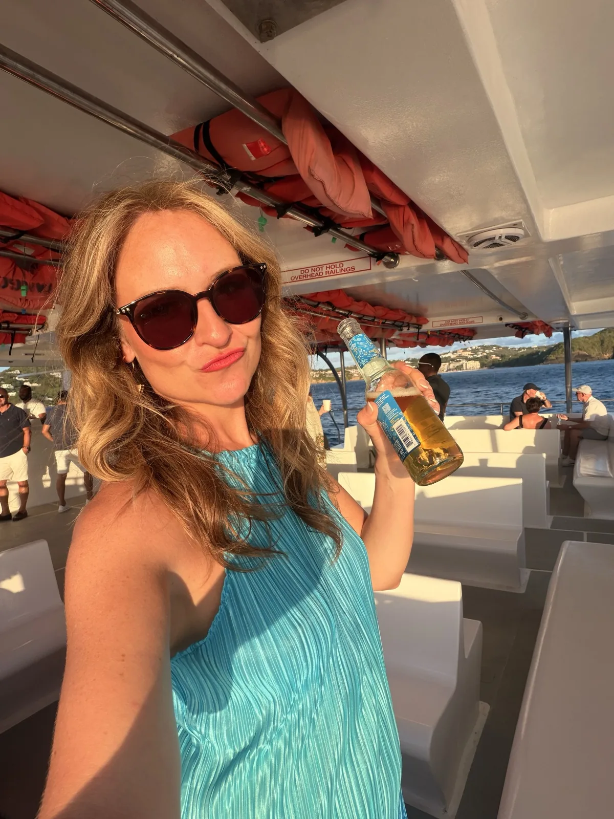 A cold drink on the boat transfer up the St Lucia coast in the late afternoon light
