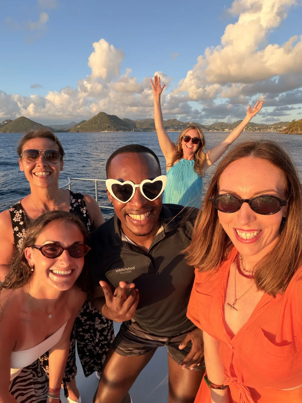 Guests and crew on the local sunset catamaran cruise along the coast