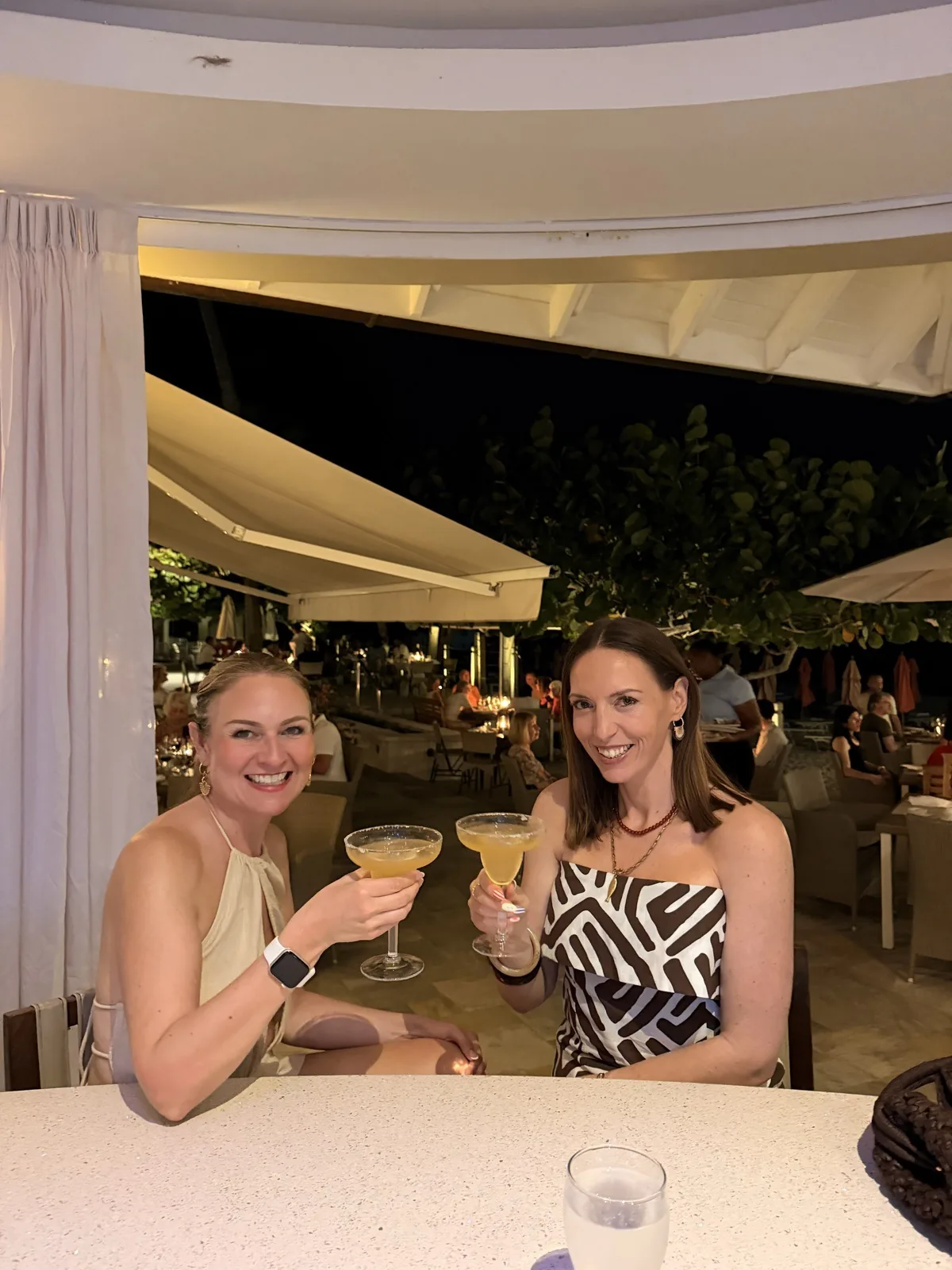 Two coupes of cocktails at the bar in the evening