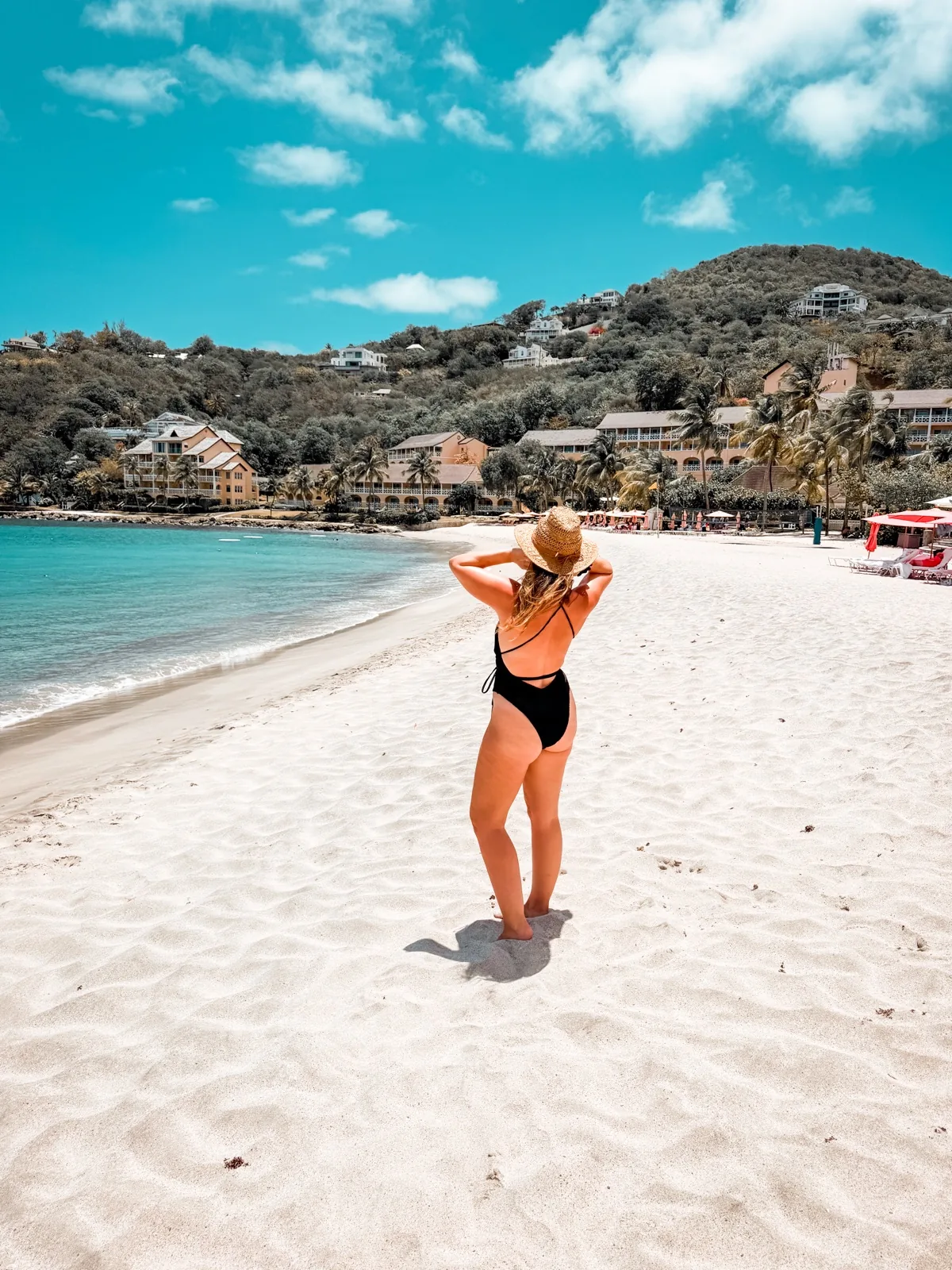 The white sand beach at the BodyHoliday, turquoise water and the resort along the hillside