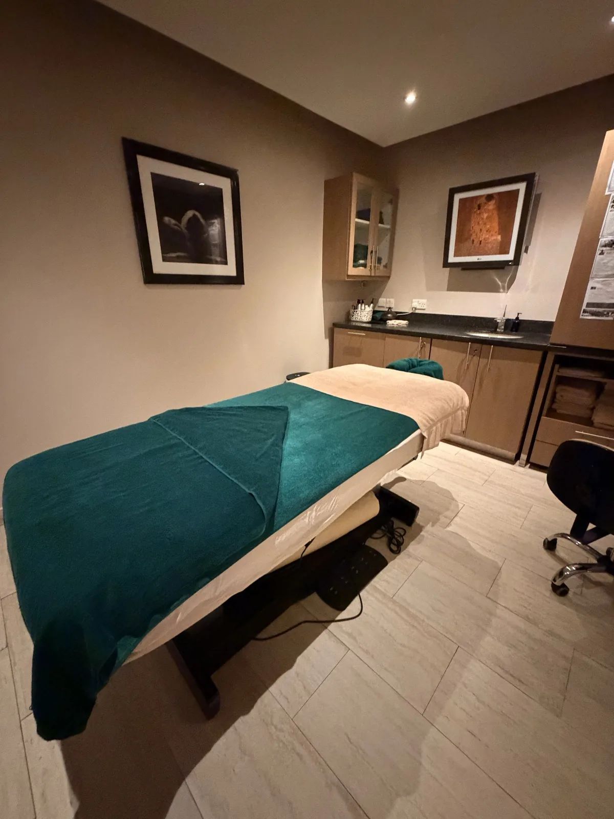 A treatment room at the BodyHoliday Wellness Centre, the table laid with a teal blanket