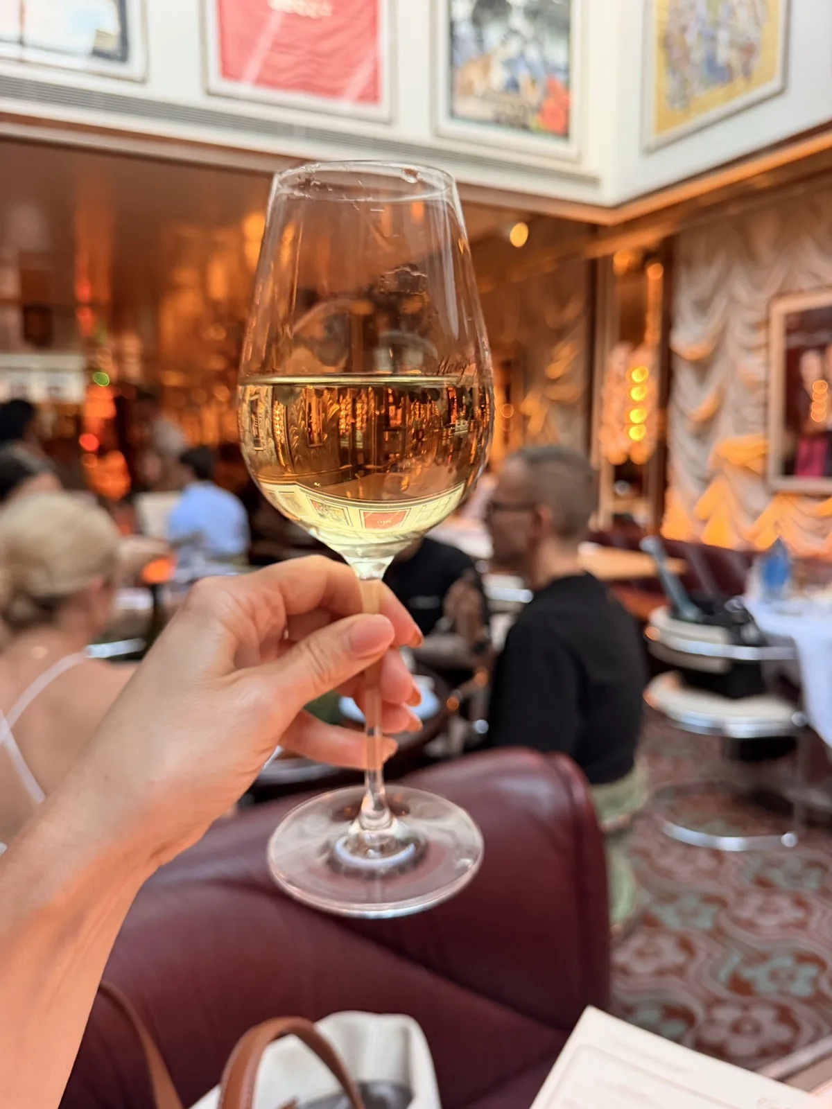 The glass of Falanghina Taburno DOC that the sommelier chose, held up in the dining room