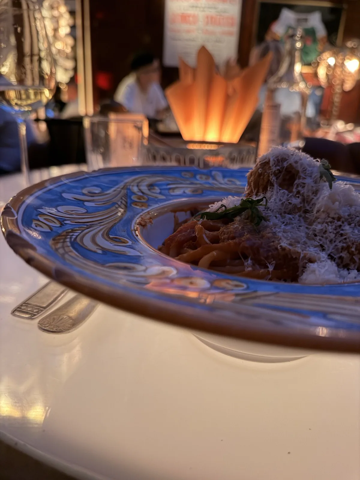 The meatballs and spaghetti on their blue painted plate, the dish that did not land