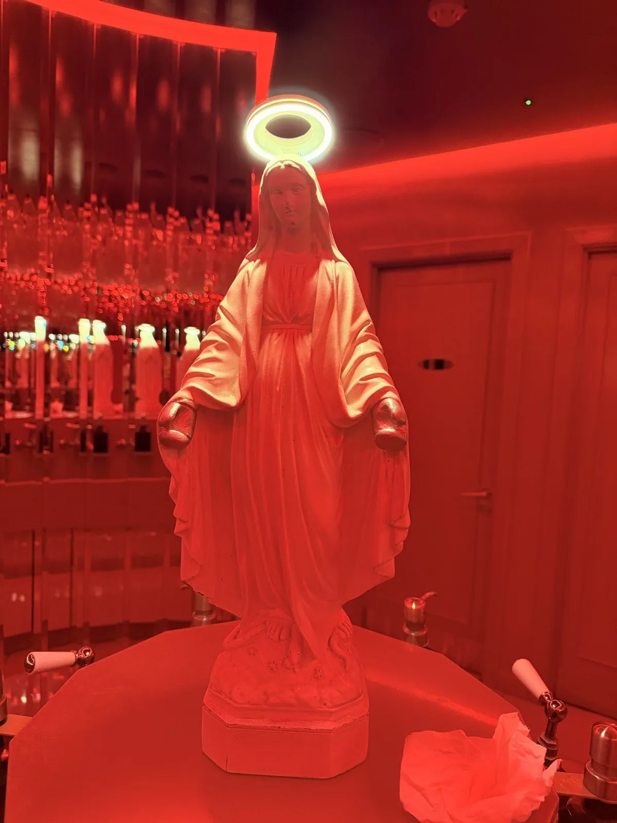 The Virgin Mary statue at the centre of the mirrored bathroom at Carlotta