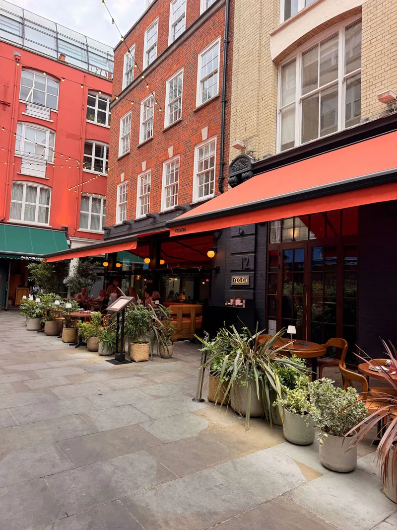 Fonda on Heddon Street, Mayfair, with outdoor tables under a red awning in the pedestrian pocket off Regent Street