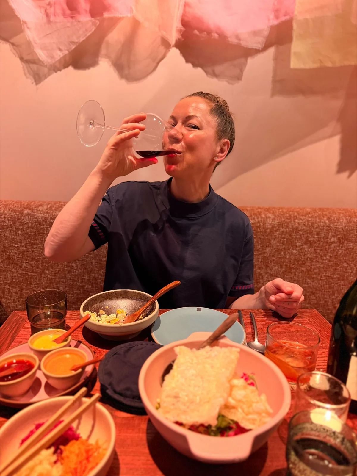 Olga tasting the Izadi Larrosa Negra 2022 Garnacha from Rioja at the table in Fonda Mayfair