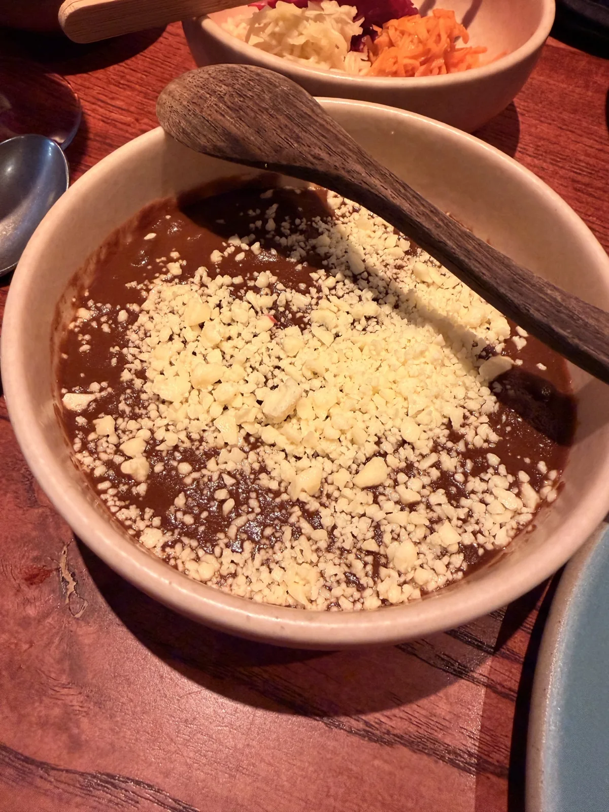 Refried beans with crumbled fresh cheese, served alongside the carnitas at Fonda Mayfair