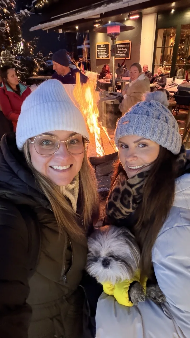 Pam, Cheryl and Daisy at the Seefeld Christmas market after dark, with the market fire behind them
