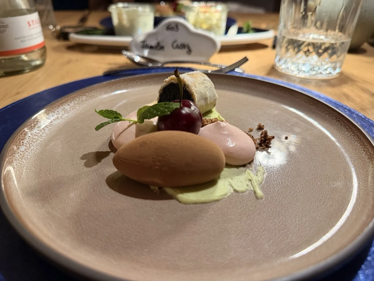 The dessert course of the Christmas Eve tasting menu at Hotel Kristall, two quenelles with a cherry