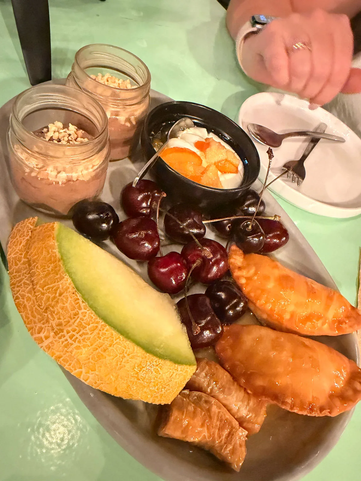The complimentary dessert platter at Karnagio: chocolate and hazelnut mousse, honey soaked pastries, baklava, cherries, melon and yoghurt