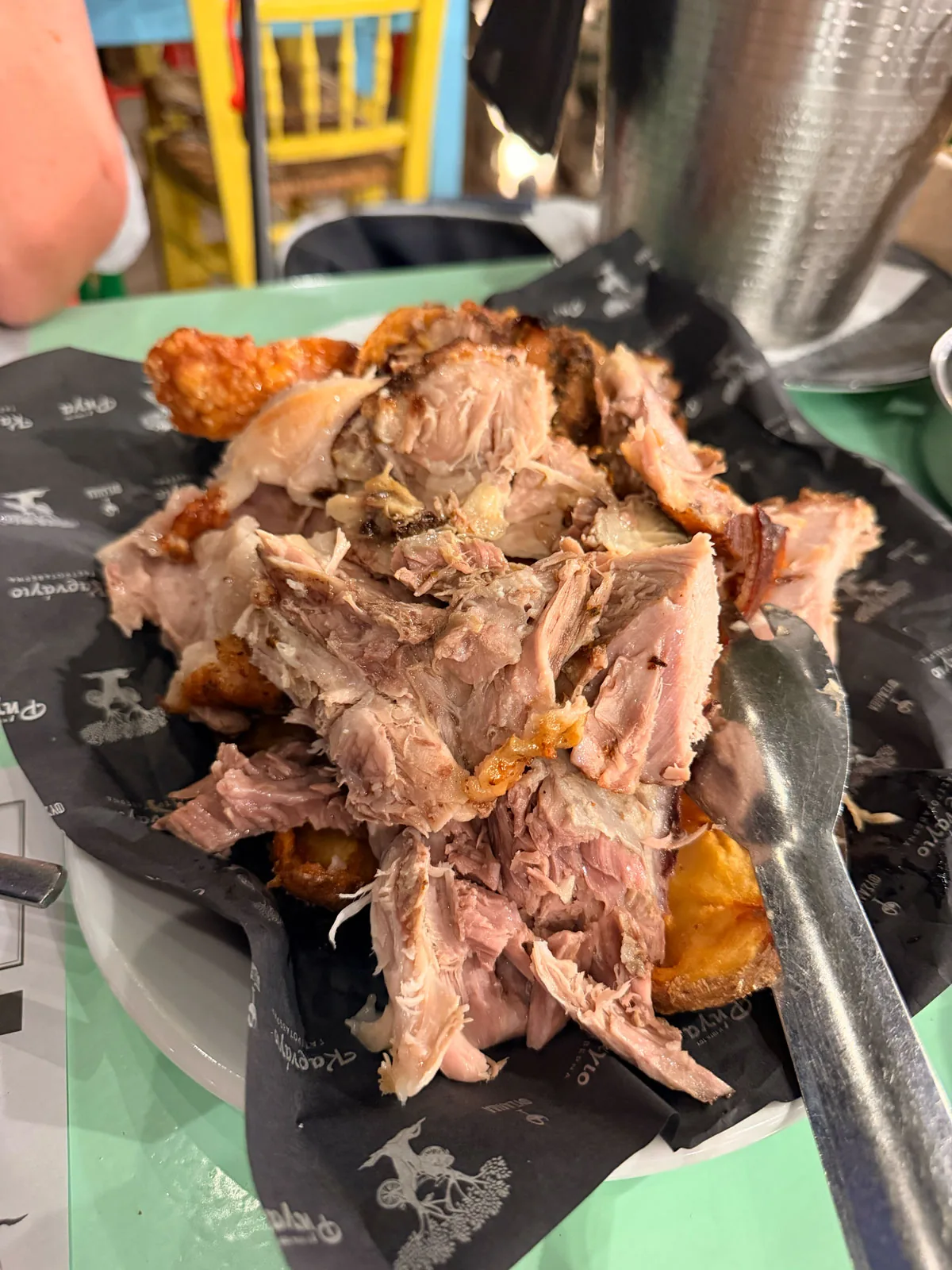 The pork shank shredded off the bone at the table, with shattering crackling and roast potatoes