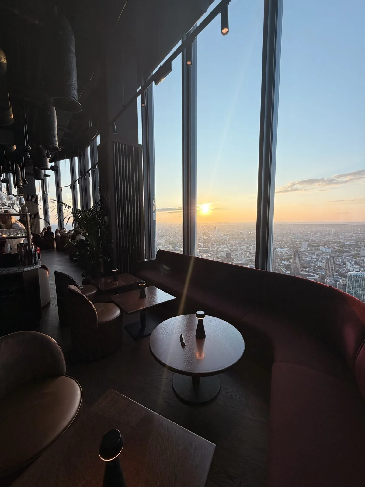 Sunset over the City of London seen through the floor to ceiling windows of Lucky Cat on Level 60 of 22 Bishopsgate