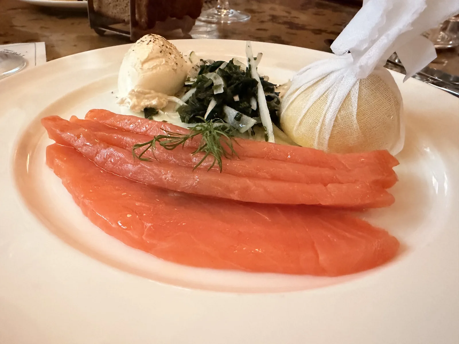 Thick cut Scottish smoked salmon at Millie's Lounge with shaved fennel salad, creme fraiche and half a lemon wrapped in muslin