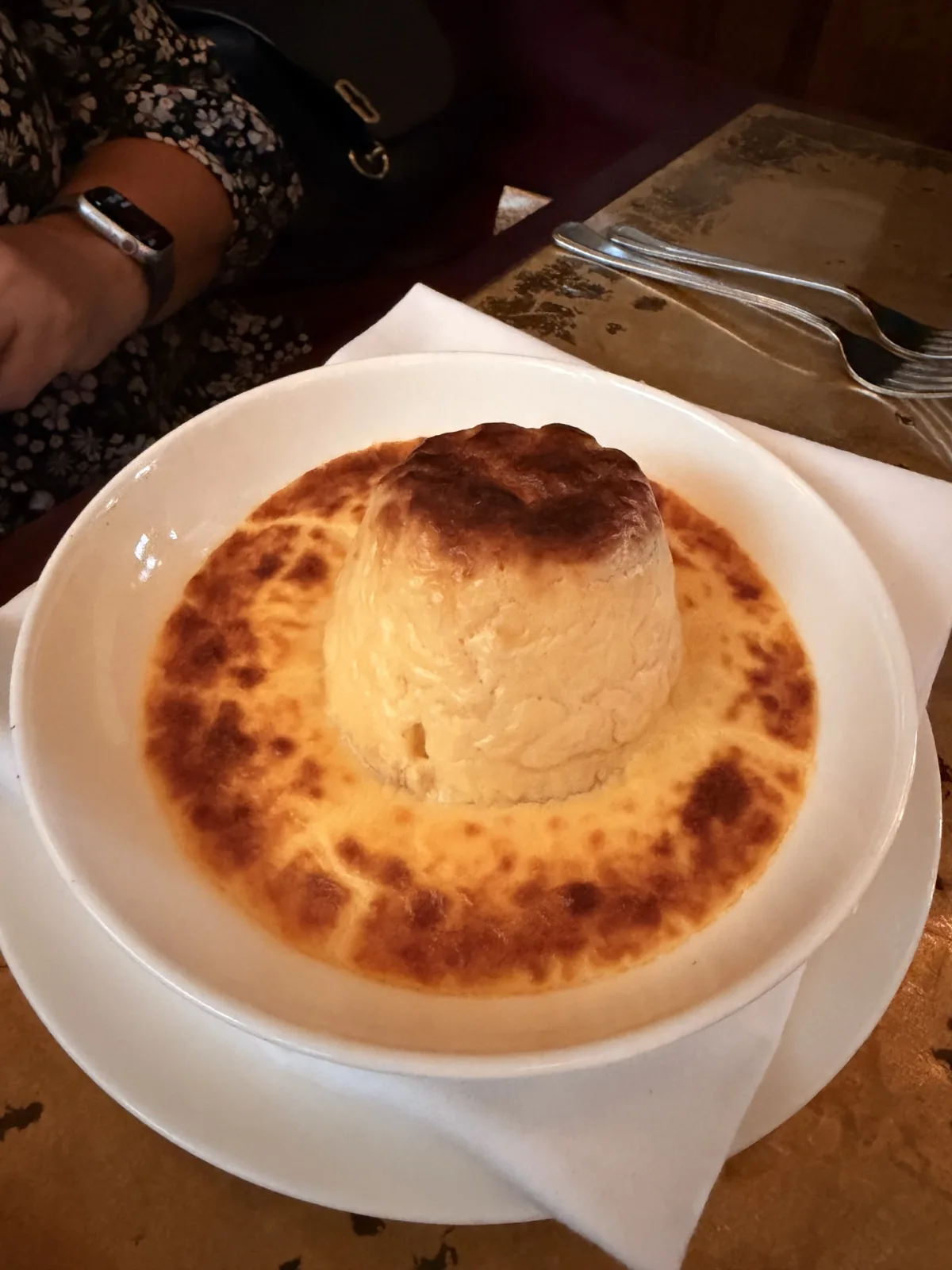 The twice baked Winterdale Shaw Cheddar souffle at Millie's Lounge, puffed and browned in a pool of blistered cheese sauce