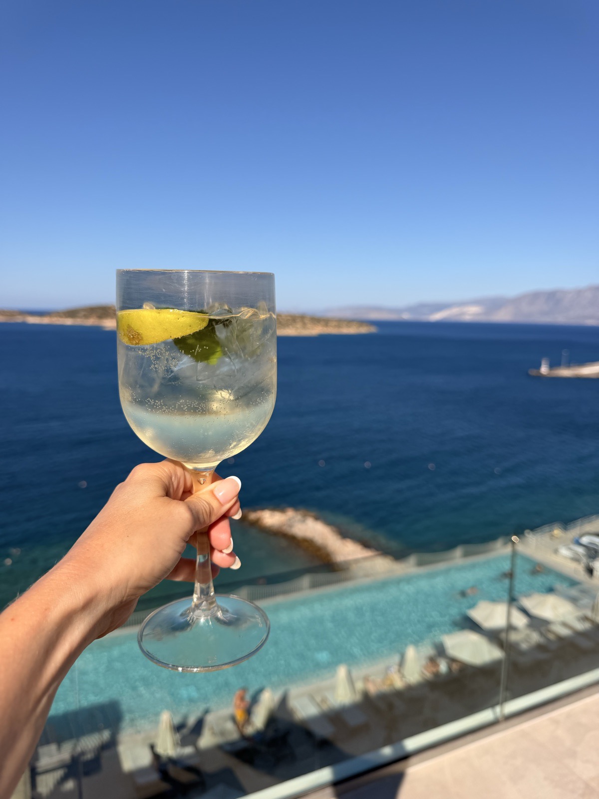 A Hugo Spritz at the ninth floor rooftop bar of NIKO Seaside Resort, with Mirabello Bay below