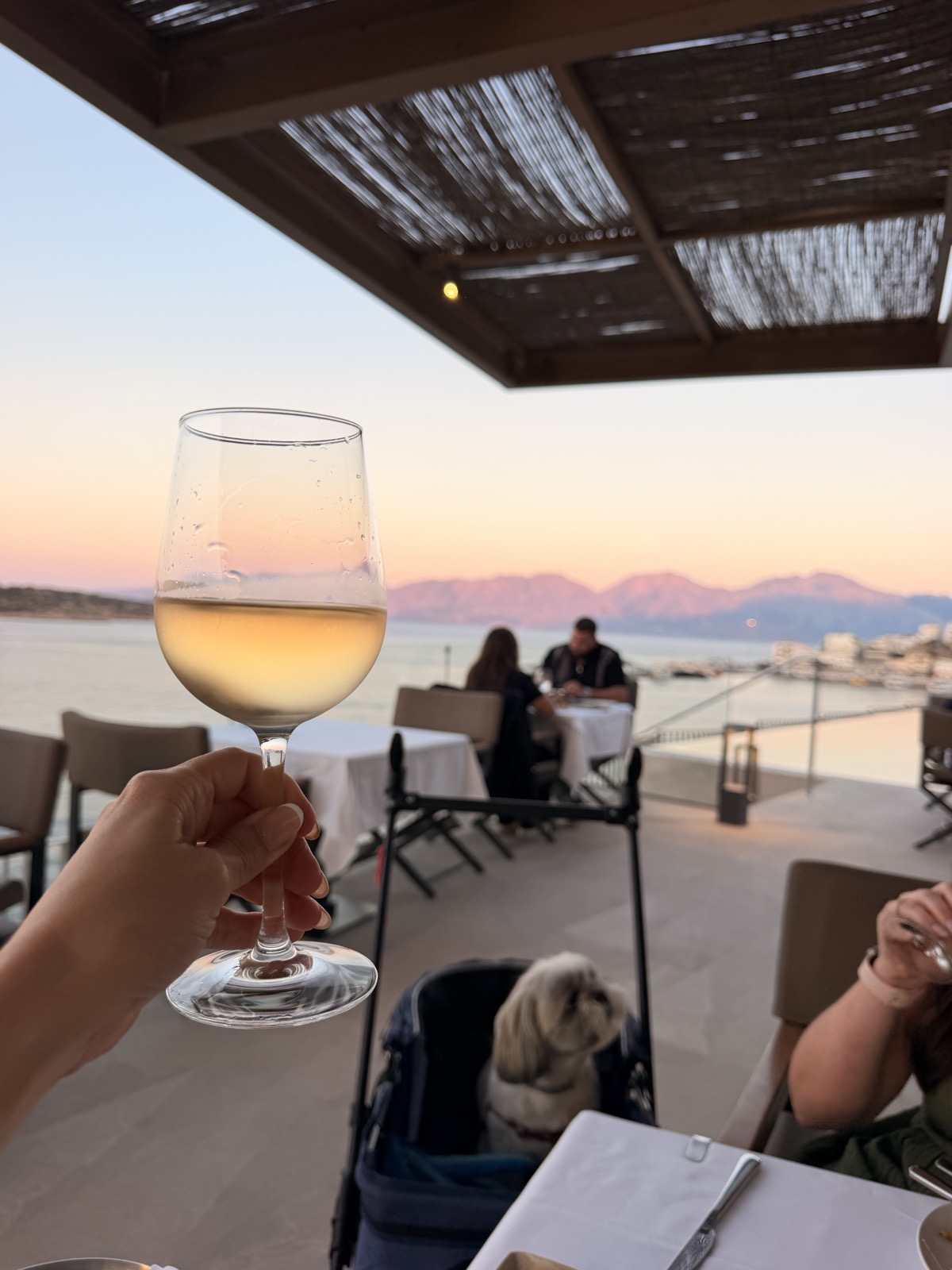 Dinner at Mira Restaurant on the fifth floor of NIKO Seaside Resort as the sun sets over the bay
