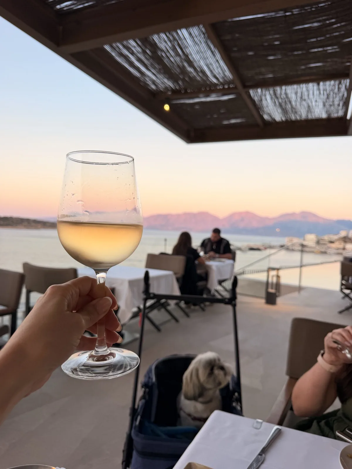 Dinner at Mira Restaurant on the fifth floor of NIKO Seaside Resort as the sun sets over the bay