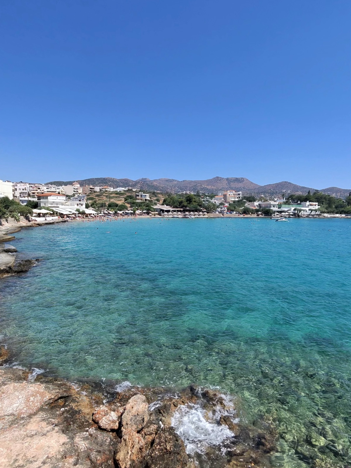 A quiet local beach twenty minutes from Agios Nikolaos, with clear turquoise water over rocks