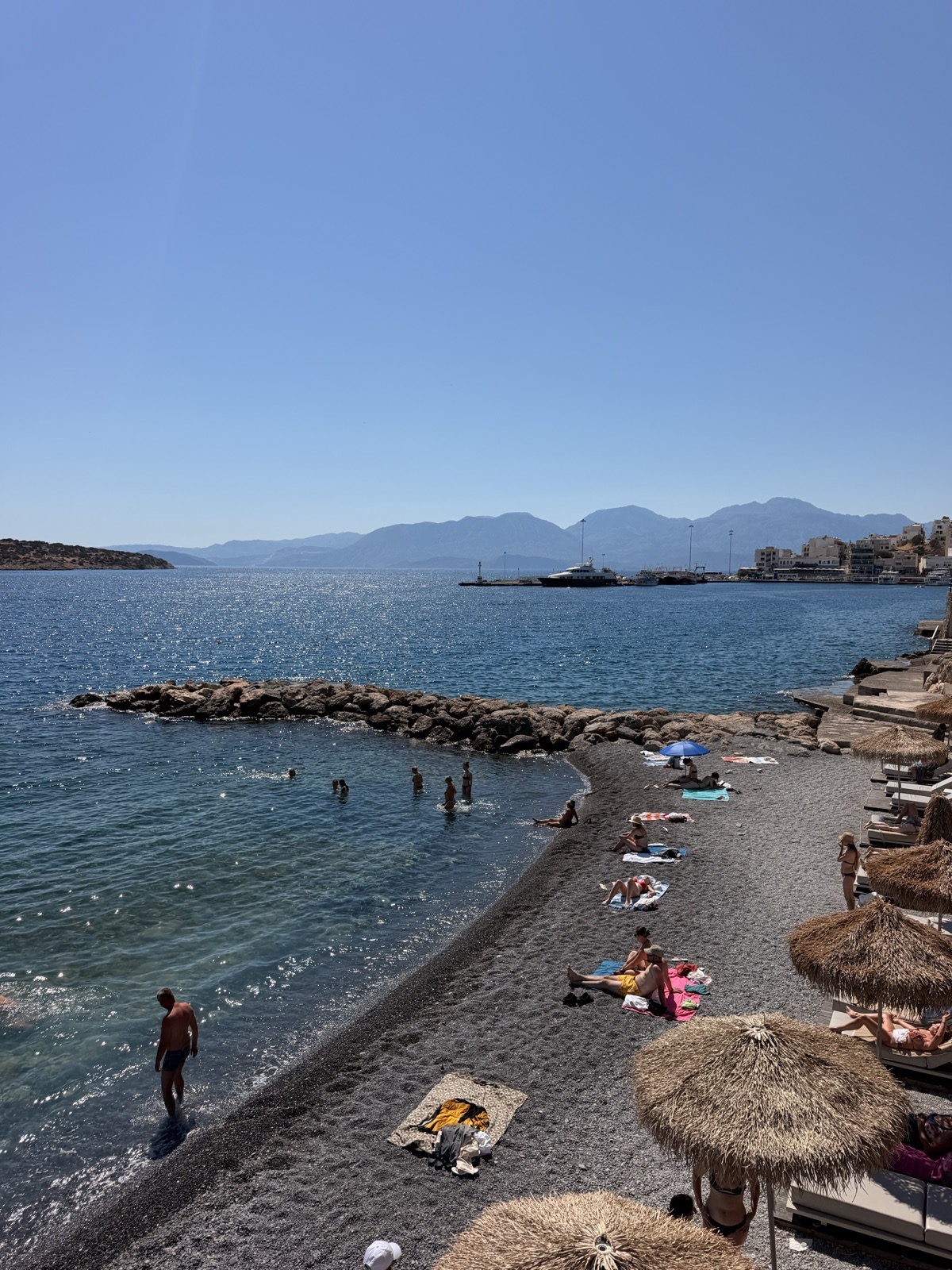 The stony beach directly across the road from NIKO Seaside Resort, where sun beds are included with your stay