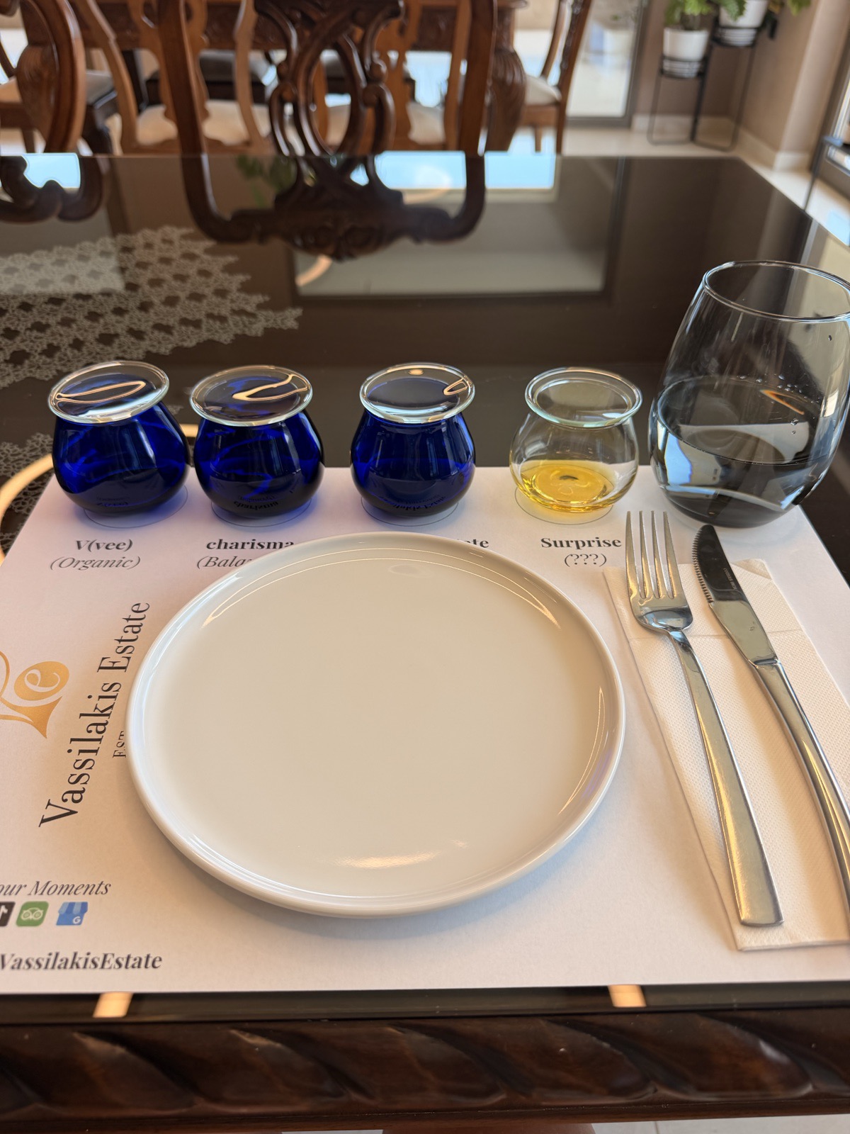 Four glass tasting bowls of extra virgin olive oil with sliced apples and fresh bread at Vassilakis Estate, Crete