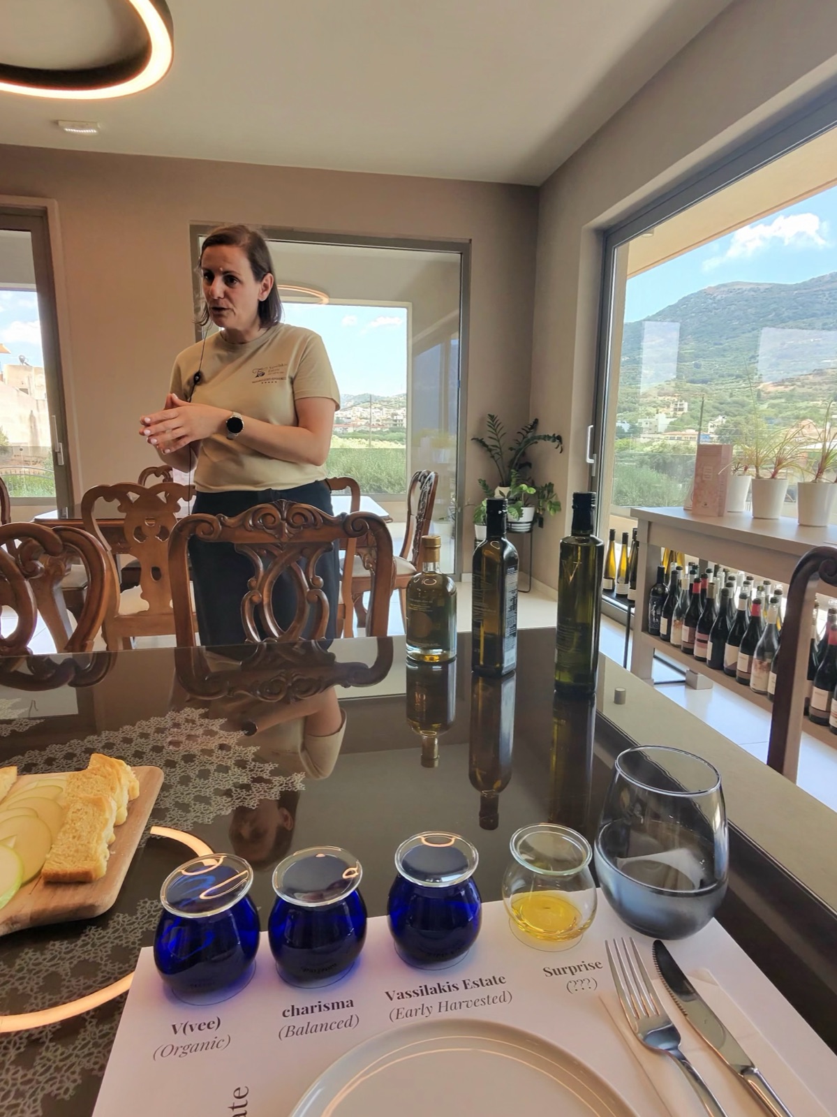 Our host talking us through the olive oil tasting at Vassilakis Estate, with the Mirambello Valley through the window