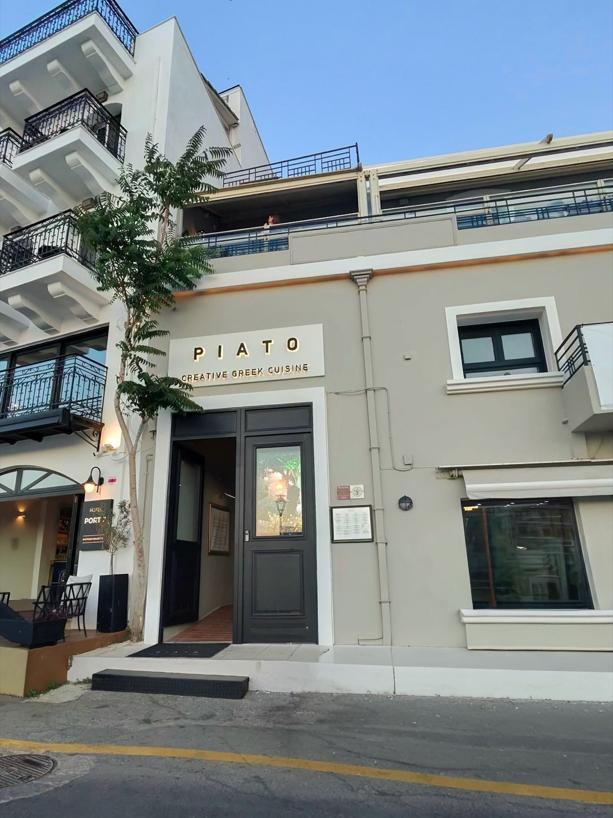 The Piato sign and entrance on a street in Agios Nikolaos, Crete