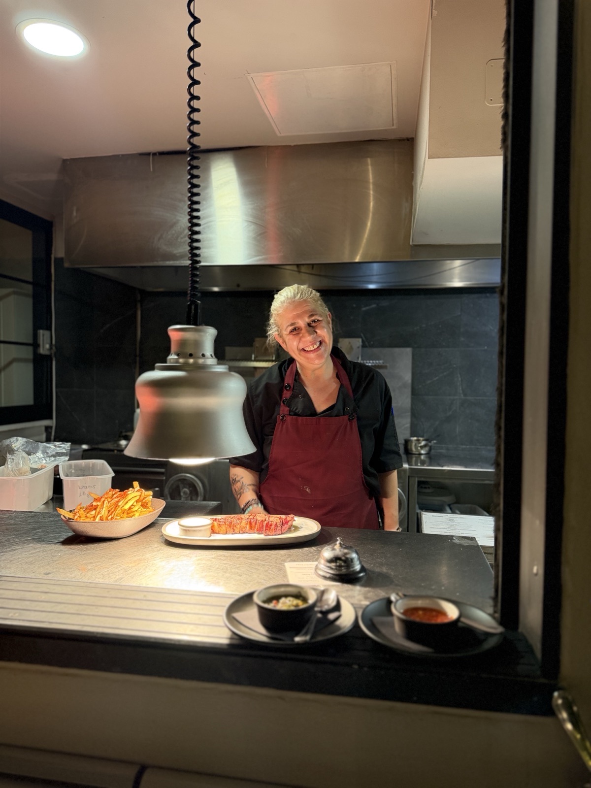 Smiling chef at the kitchen pass