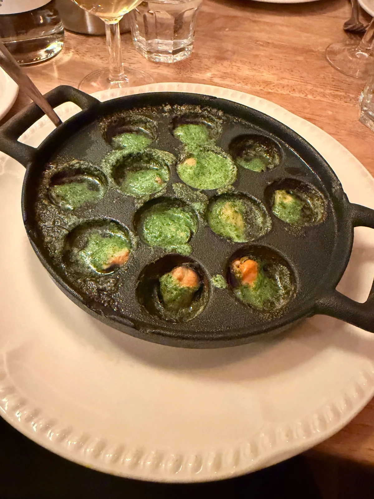 Grilled mussels in garlic, parsley and Pernod butter served in a dimpled snail dish at Prix Fixe Brasserie, Dean Street, Soho