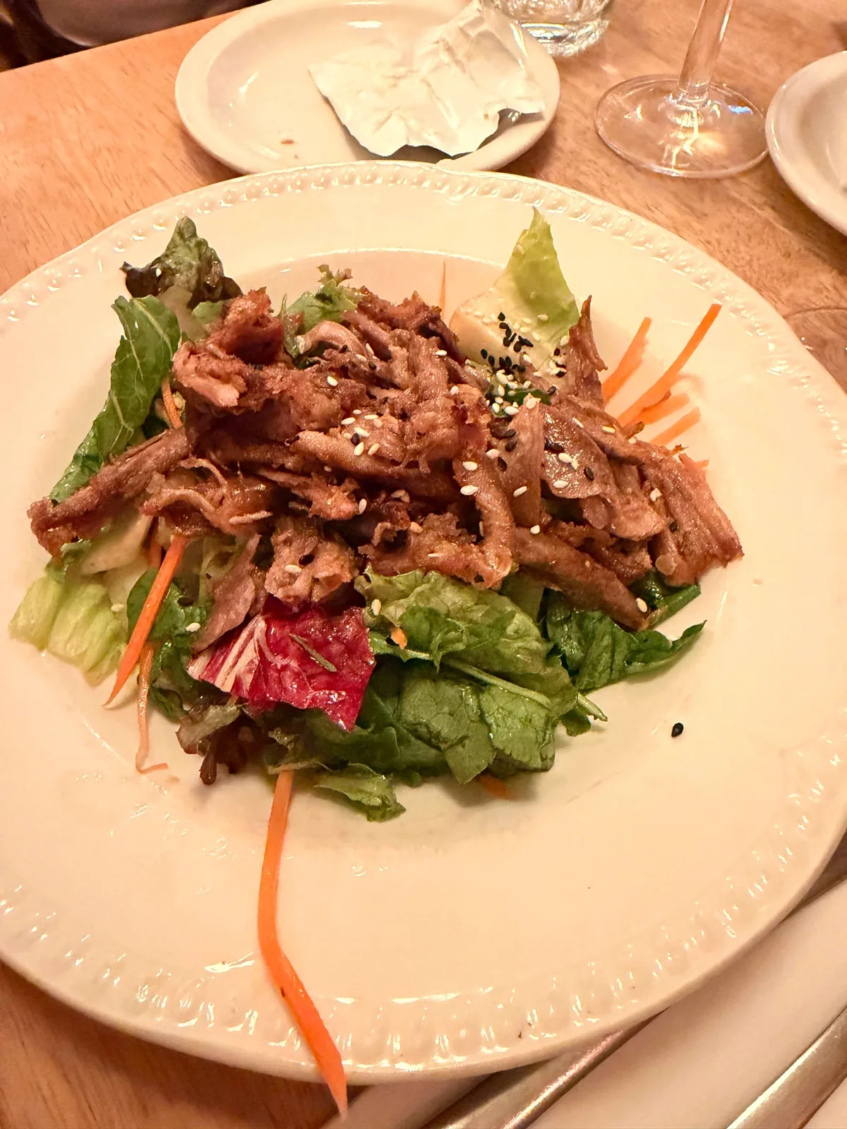 Warm crispy duck salad with carrot ribbons, spring onion, sesame seeds and an Asian dressing at Prix Fixe Brasserie