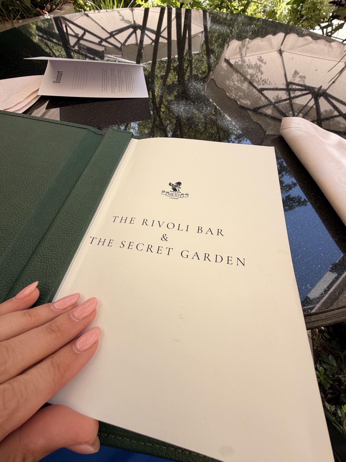 The Rivoli Bar and Secret Garden menu open at its title page, where the minimum spend is listed