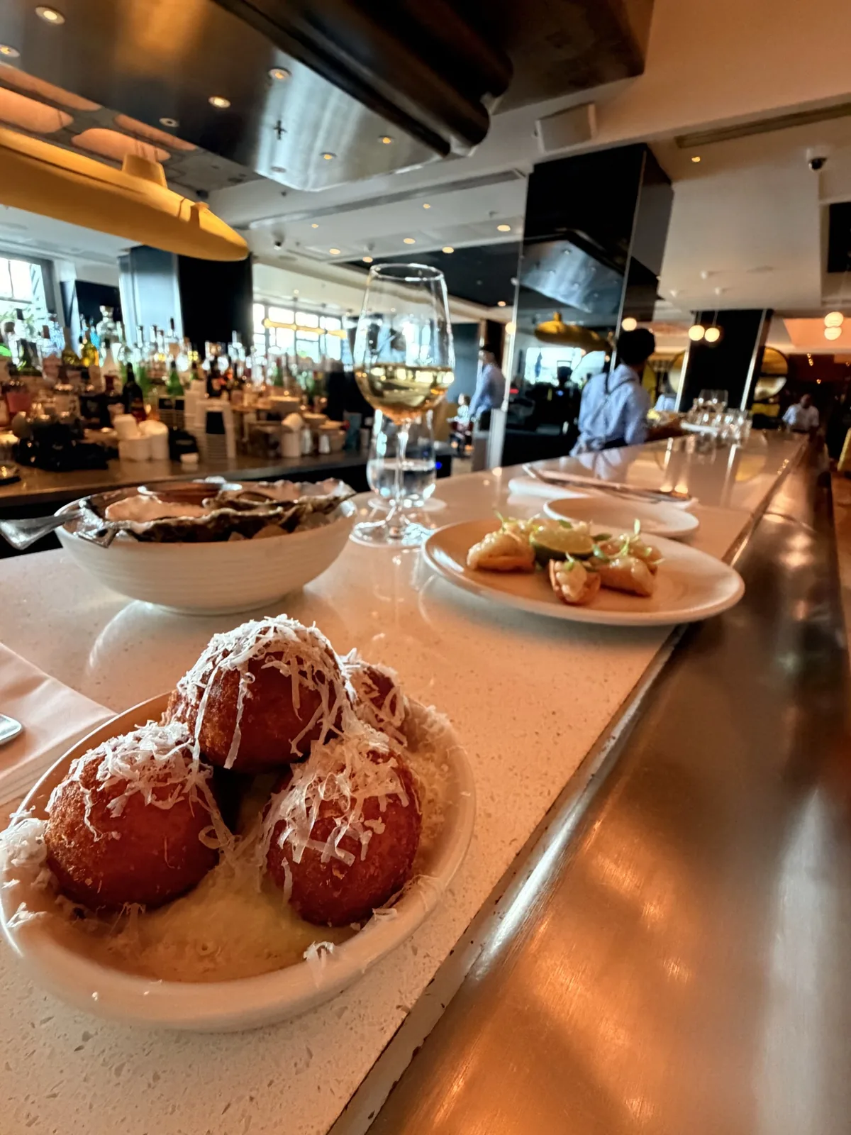 Four cheese croquettes with jalapeño mayonnaise and other small plates along the bar at Sea Containers London
