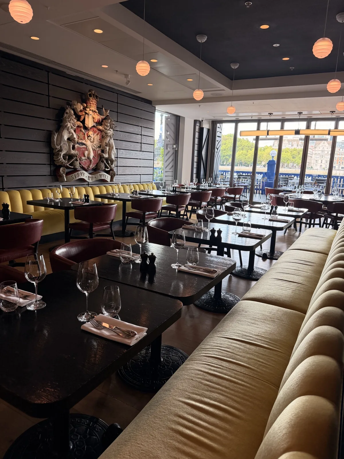The Sea Containers Restaurant on the ground floor, banquette seating running towards the windows and the river