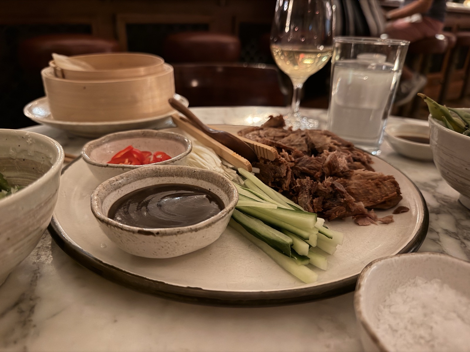 Crispy aromatic duck leg with sriracha hoisin and pancakes at Kaia, The Ned