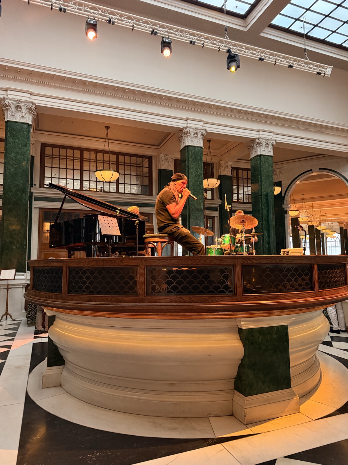 A live singer performing on the Nickel Stage at The Ned on a Saturday night